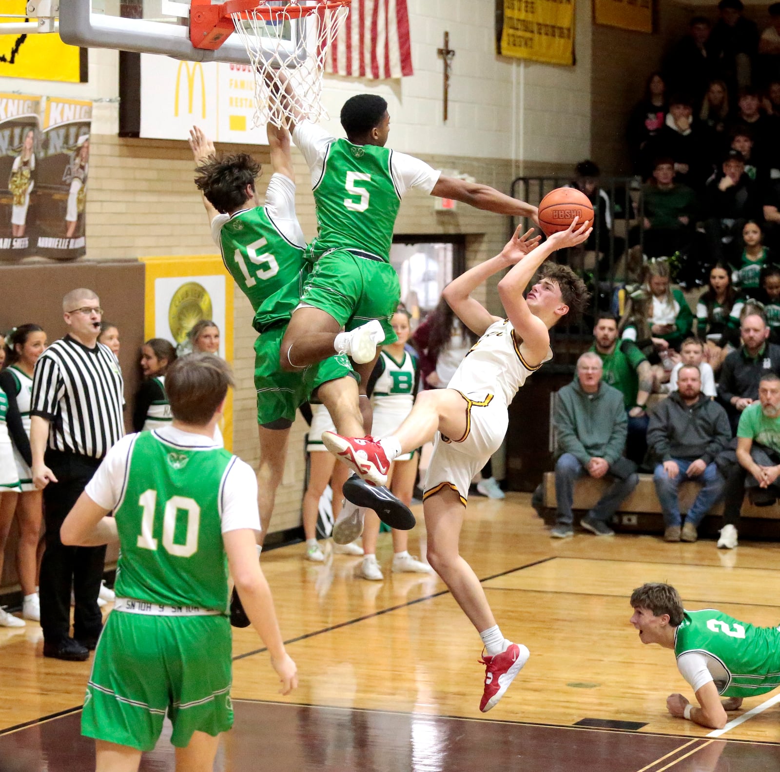 Alter senior Grant Guess tries to get up an off balance shot attempt over several Badin defenders. Badin defeated Alter 66-55 in a Greater Catholic League Co-Ed game on Friday, Jan. 30, 2026 in Kettering. STEVEN WRIGHT / STAFF