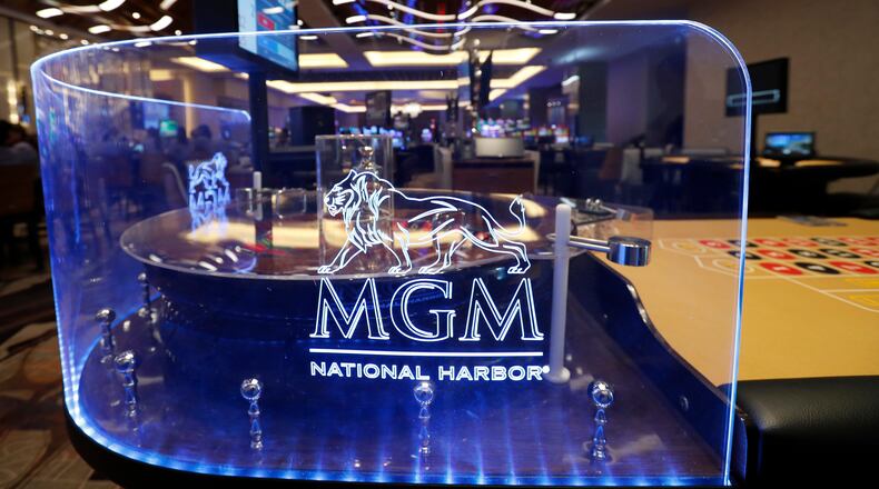 FILE - The MGM National Harbor logo is seen around a roulette wheel in the casino during a preview tour of the MGM National Harbor, Dec. 2, 2016 in Oxon Hill, Md. (AP Photo/Alex Brandon, File)
