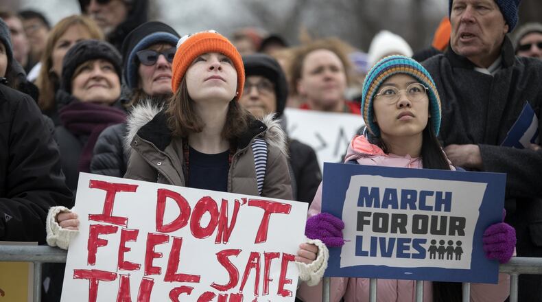 Madeline Pollock, left, 14, and Lena Brockway, 15, hold signs as thousands gather in Union Park for the March for our Lives protest in Chicago on Saturday March 24, 2018. (Erin Hooley/Chicago Tribune/TNS)