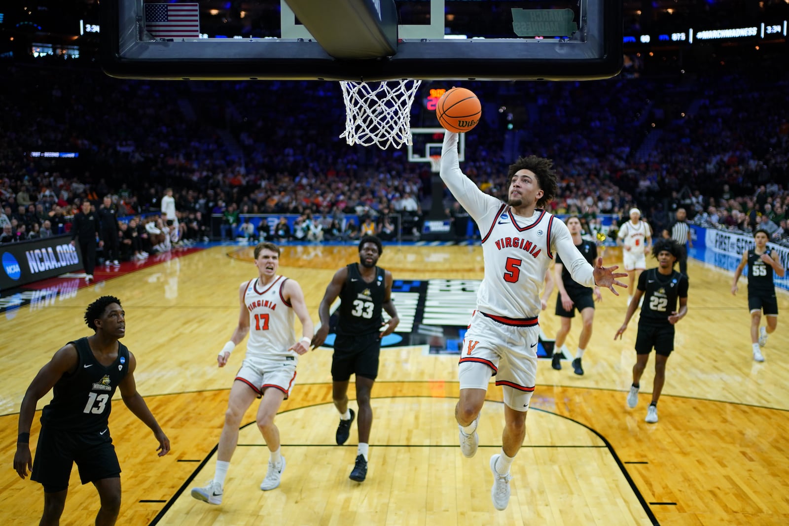Virginia's Sam Lewis goes up for a dunk during the second half against Wright State in the first round of the NCAA college basketball tournament, Friday, March 20, 2026, in Philadelphia. (AP Photo/Matt Slocum)