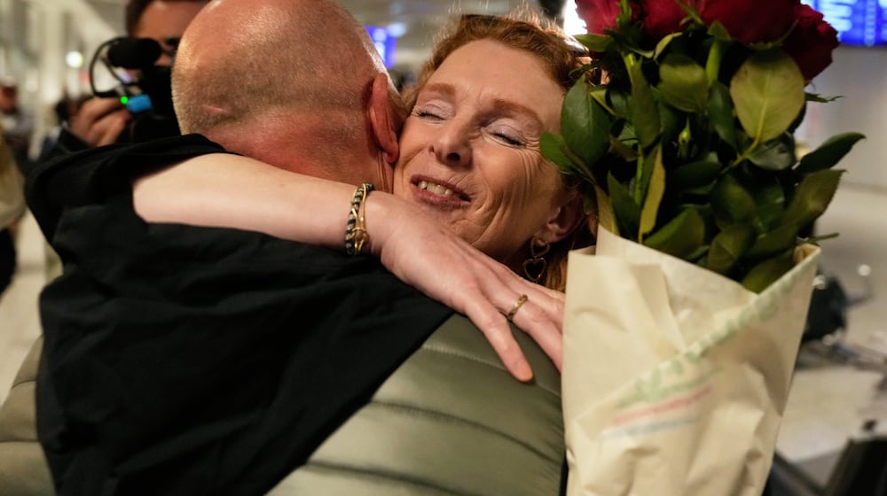 People arrive at the International Airport in Frankfurt, Germany, after being evacuated from Dubai on a commercial flight, Tuesday, March 3, 2026. (AP Photo/Michael Probst)