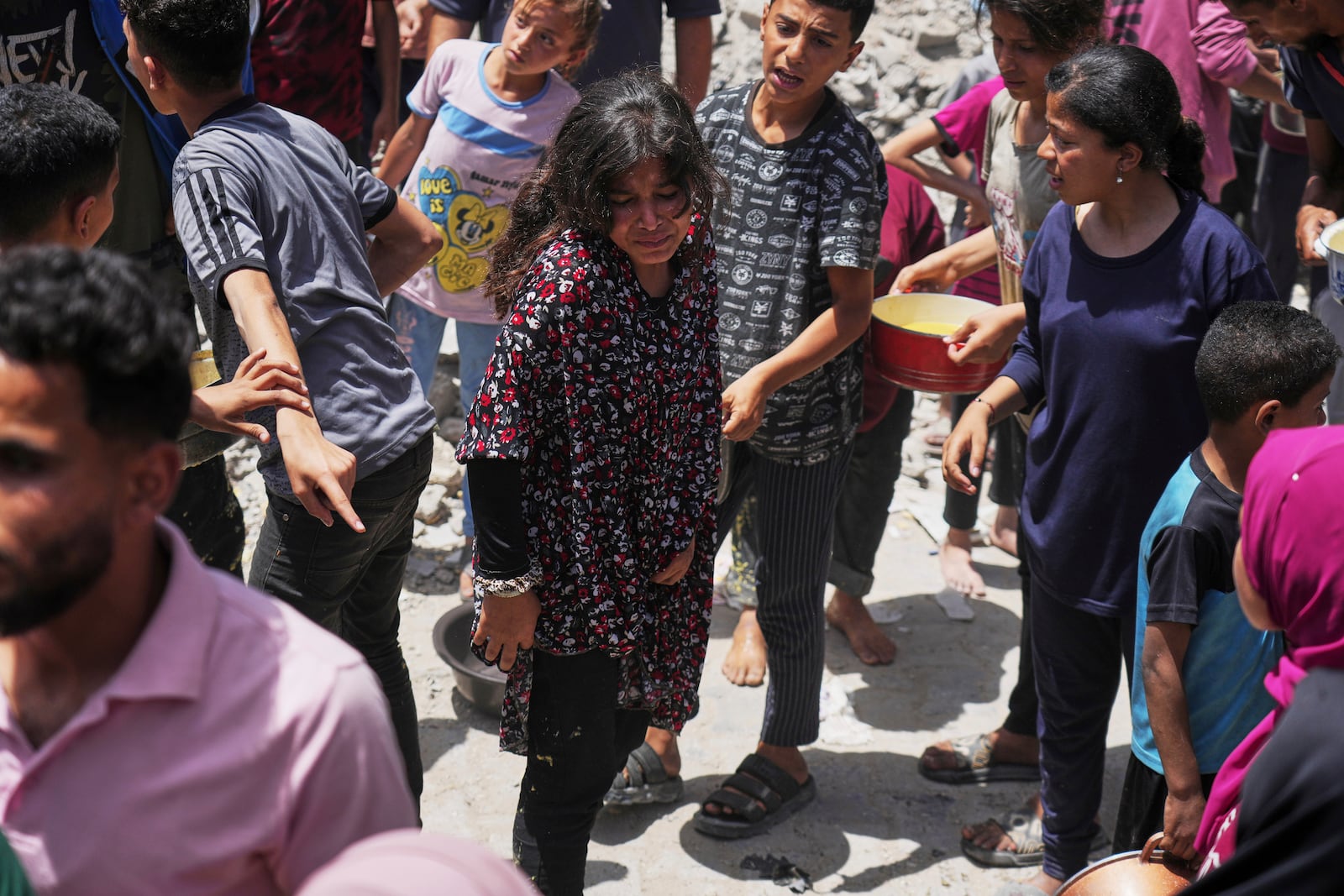 Palestinians line up for donated food at a community kitchen in Jabalia, in the northern Gaza Strip, on Monday, May 19, 2025. (AP Photo/Jehad Alshrafi)