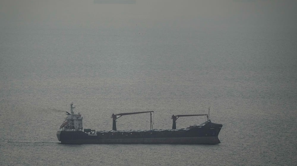 A cargo ship carrying vehicles sails through the Arabian Gulf toward the Strait of Hormuz in the United Arab Emirates, Sunday, March 22, 2026. (AP Photo)