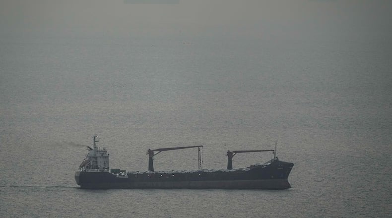 A cargo ship carrying vehicles sails through the Arabian Gulf toward the Strait of Hormuz in the United Arab Emirates, Sunday, March 22, 2026. (AP Photo)