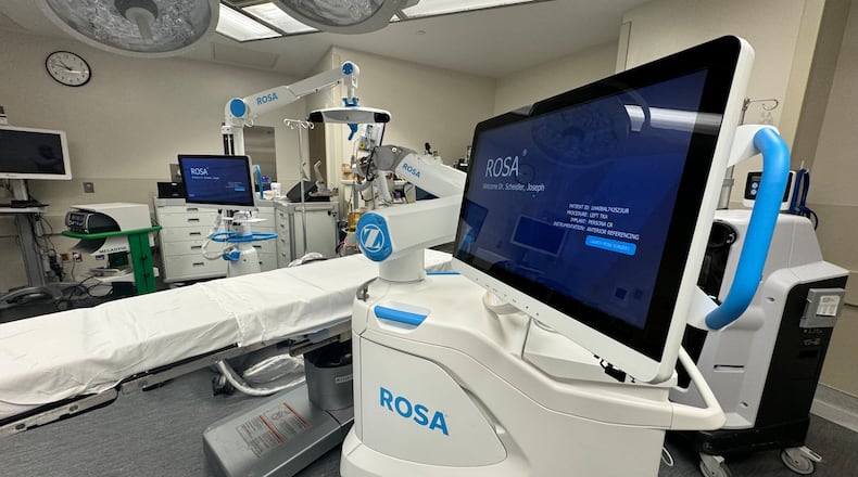 Kettering Health Hamilton is a leader in robotic surgery. Pictured is the Rosa system, the tool orthopedic surgeon Dr. Joseph Scheidler uses in all of his knee replacement surgeries. Scheidler said advancements are coming where other joint replacements, such as hips and ankles, can be used with robotic-assisted tools, like the Rosa system. MICHAEL D. PITMAN/STAFF