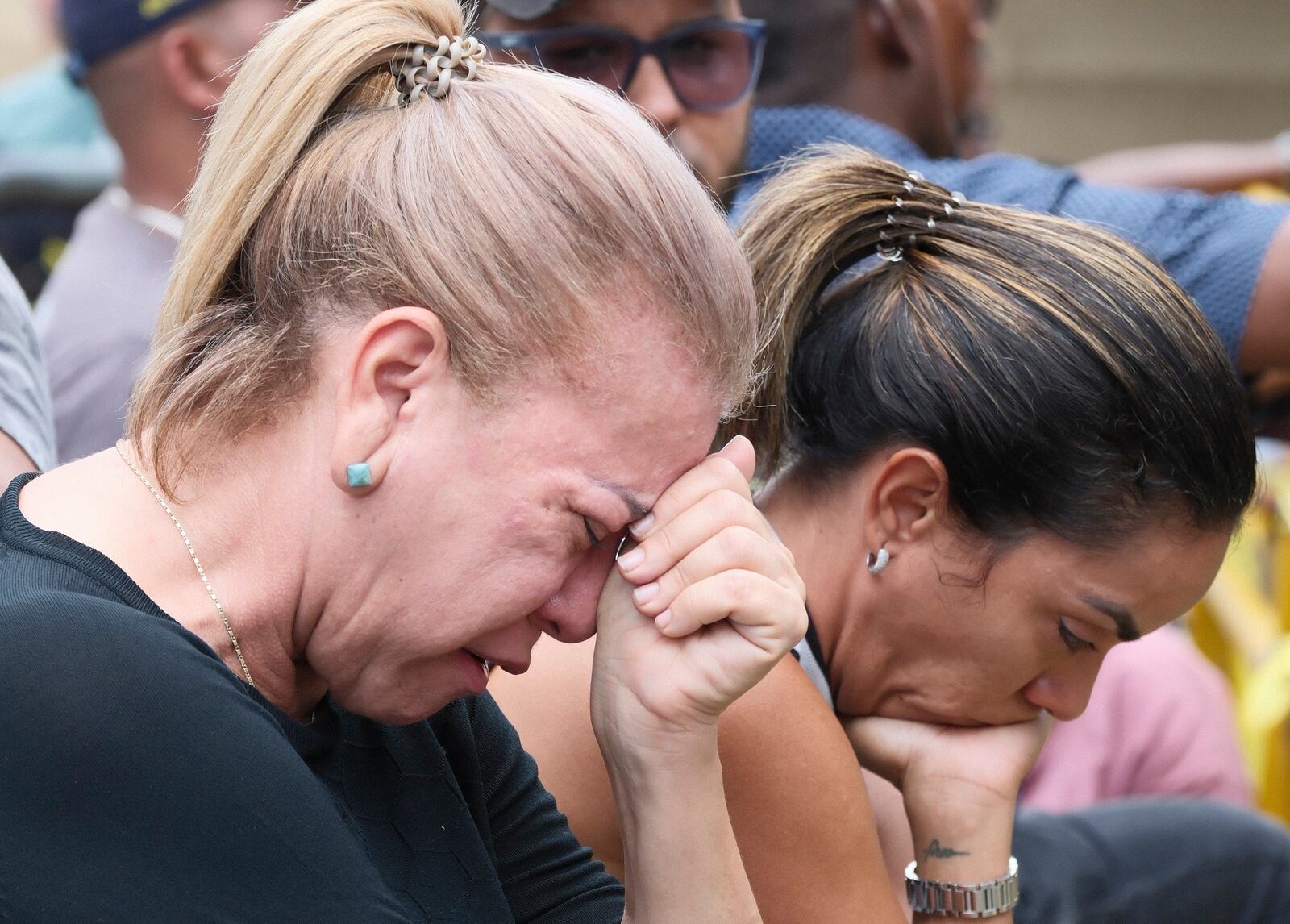 Women cry during the search for survivors at the Jet Set nightclub after its roof collapsed two nights prior during a merengue concert in Santo Domingo, Dominican Republic, Wednesday, April 9, 2025. (AP Photo/Ricardo Hernandez)