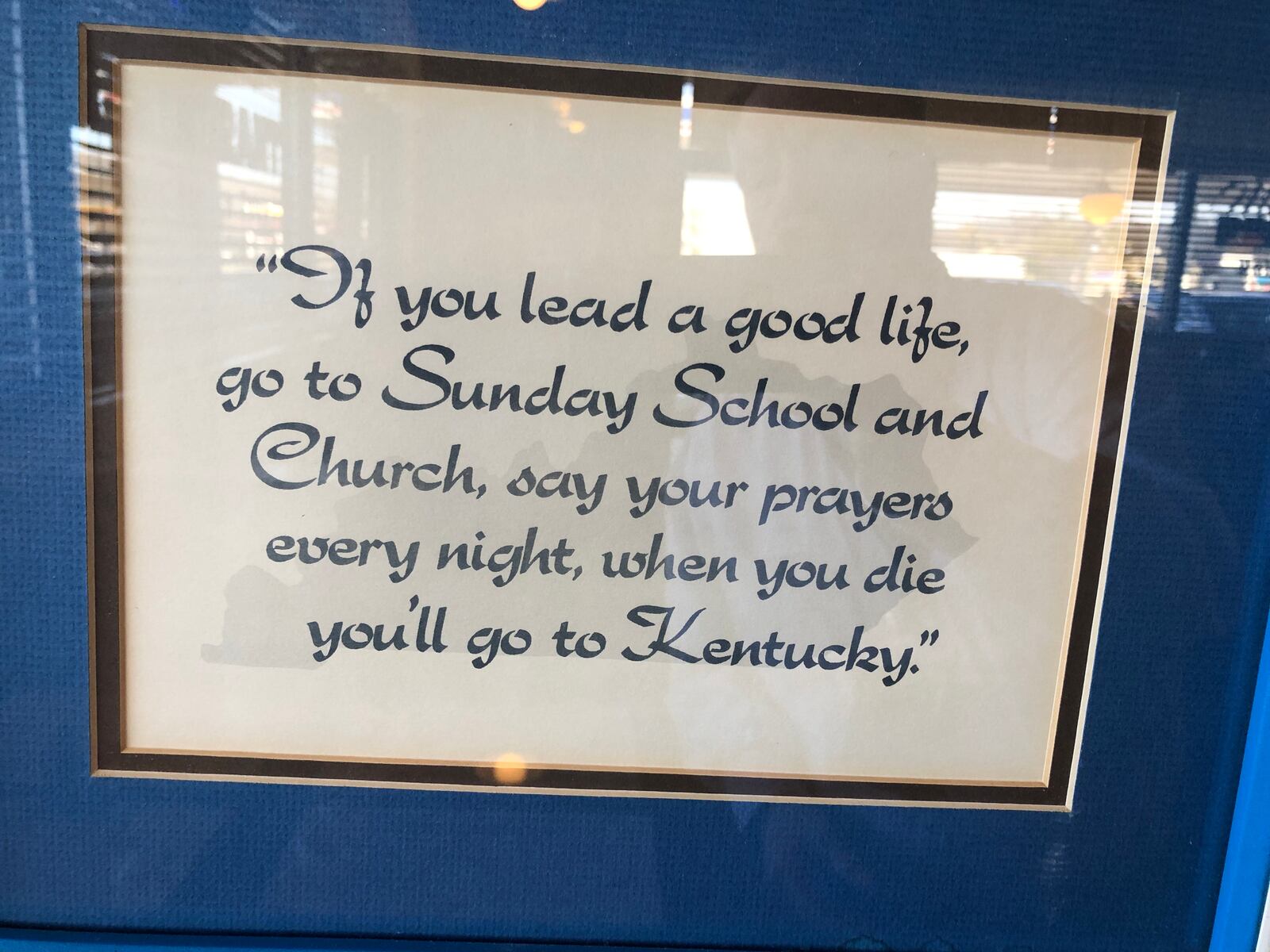 Hilda Ratliff, the owner of Mom's Restaurant in Franklin, has lined the walls with University of Kentucky basketball memorabilia and signs. RICK McCRABB/STAFF