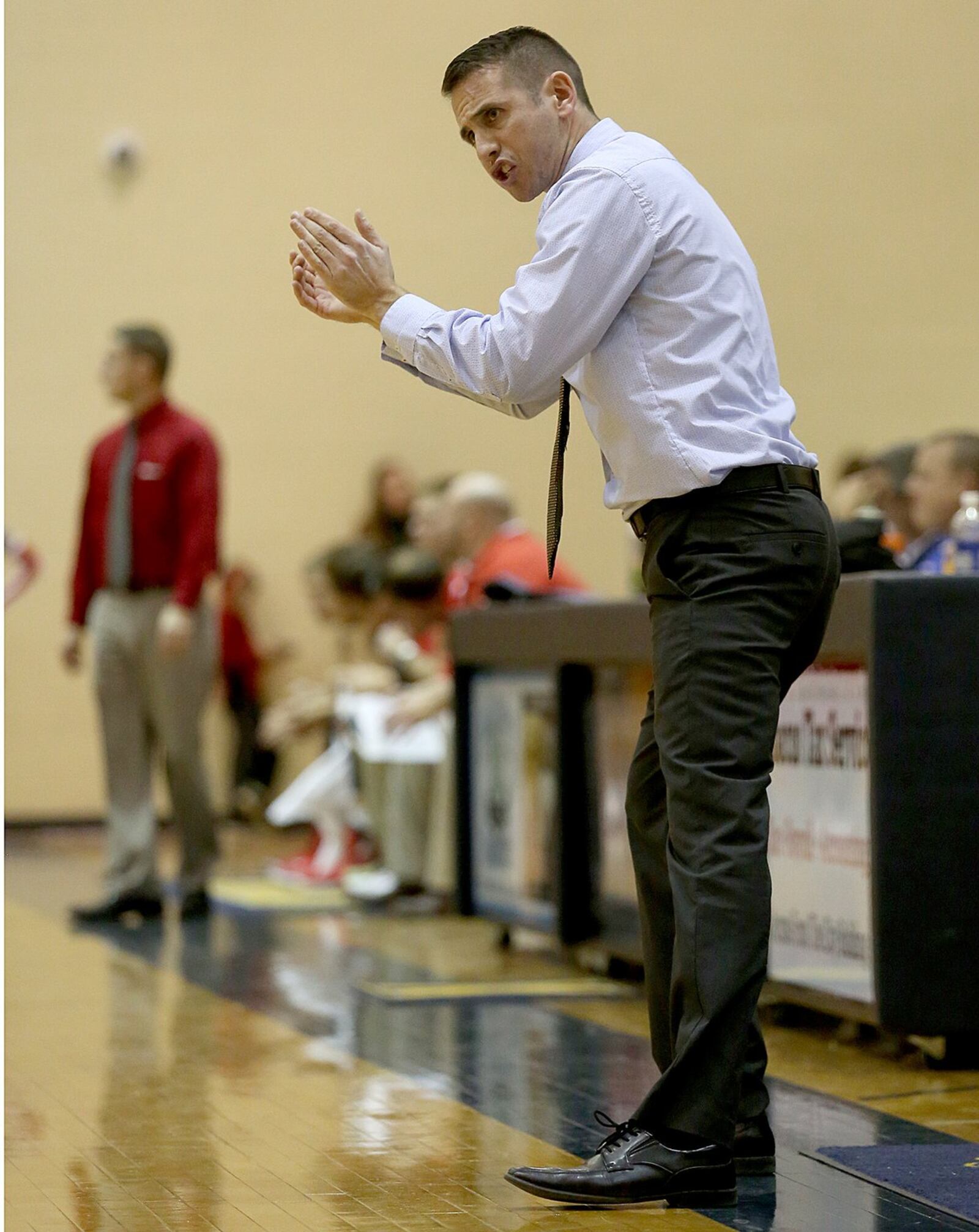 Monroe coach Kenny Molz applauds his team during a game against visiting Carlisle on Dec. 8, 2015. JOURNAL-NEWS FILE PHOTO