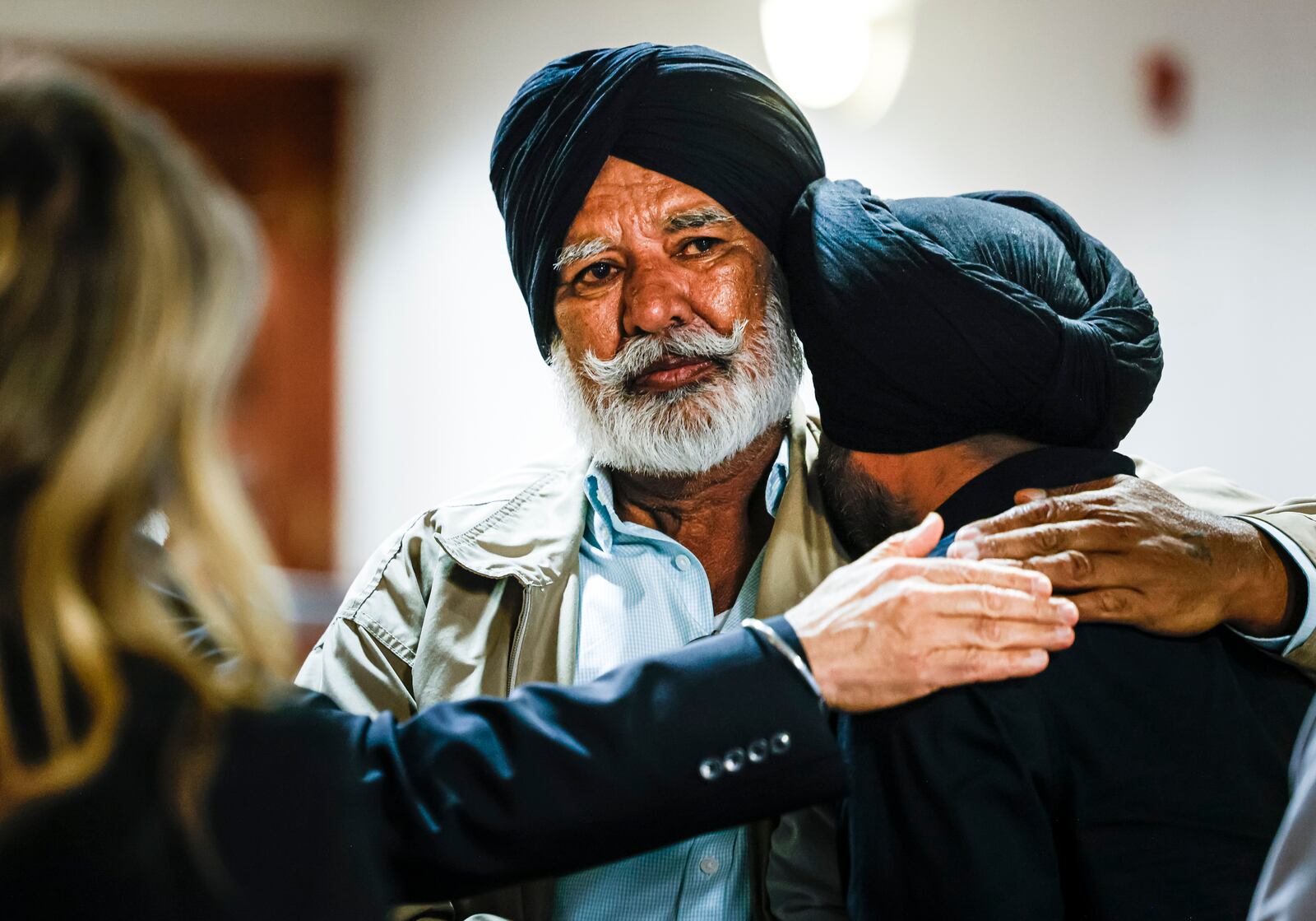 Swarn Singh, left, and Jasdeep Singh are filled with emotion after the verdict is read in the retrial of Gurpreet Singh, indicted in the deaths of four family members in 2019 in their West Chester home, Friday, May 10, 2024 in Butler County Common Pleas Court in Hamilton. Singh was found guilty of all counts by a three-judge panel.  NICK GRAHAM/STAFF
