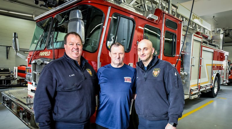 Duane Sparks (middle) with Fairfield firefighter paramedics Rob Lance (left) and Scott Goller (right) at the Fairifield Fire Department headquarters on Nilles Road. Sparks has developed a special relationship with the Fairfield Fire Department.