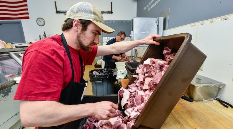 Zach Roberts cuts meat for sausage Wednesday, April 1, 2020 at Dave’s Quality Meats of West Chester. Dave’s Quality Meats of West Chester on Smith Road has changed the way they do business during the coronavirus pandemic. They are no longer allowing customers inside the store and are taking call-in orders for curbside pick-up. Orders must be placed 24 hours in advance. NICK GRAHAM / STAFF
