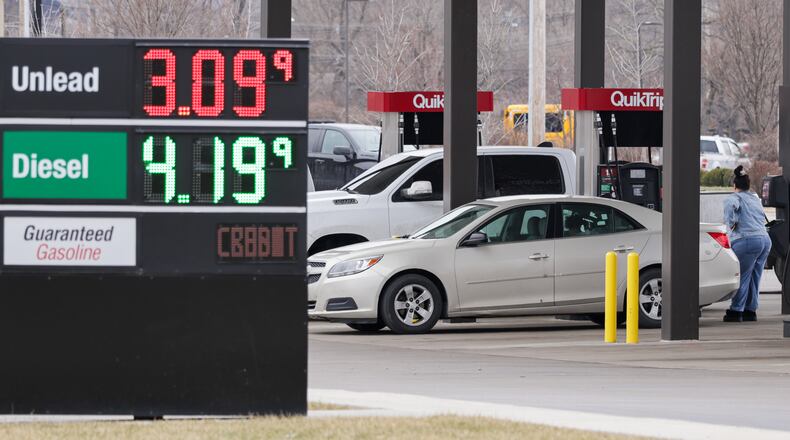 A customer waits as she pumps gas into her sedan at QuikTrip on Edwin C. Moses Boulevard in Dayton on Monday, March 2. Gas prices are expected to increase after military operations began in Iran over the weekend. BRYANT BILLING / STAFF