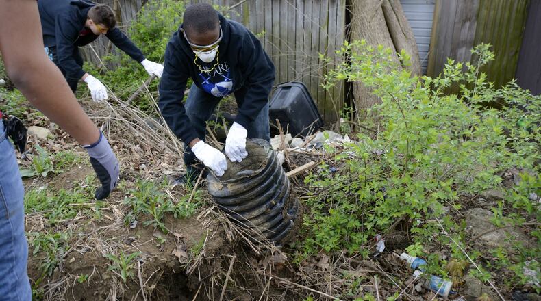Fairfield Twp. will renew its annual spring cleanup day on April 10 in conjunction with Habitat for Humanity's Rock the Block program, though Habitat's community projects will span the Greater Cincinnati region. Pictured is work during Habitat for Humanity’s Rock the Block in April 2019 in Fairfield Twp. During that event, hundreds of volunteers filled more than 11 Dumpsters with trash and debris from the Five Points area. MICHAEL D. PITMAN/FILE