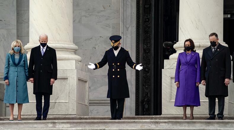Pesident Joe Biden, second from left, and Vice President Kamala Harris, second from right, along with spouses Jill Biden, left, and Doug Emhoff, are invited to review the troops following the inauguration ceremony at the U.S. Capitol on Wednesday, Jan. 20, 2021. (Amr Alfiky/The New York Times)