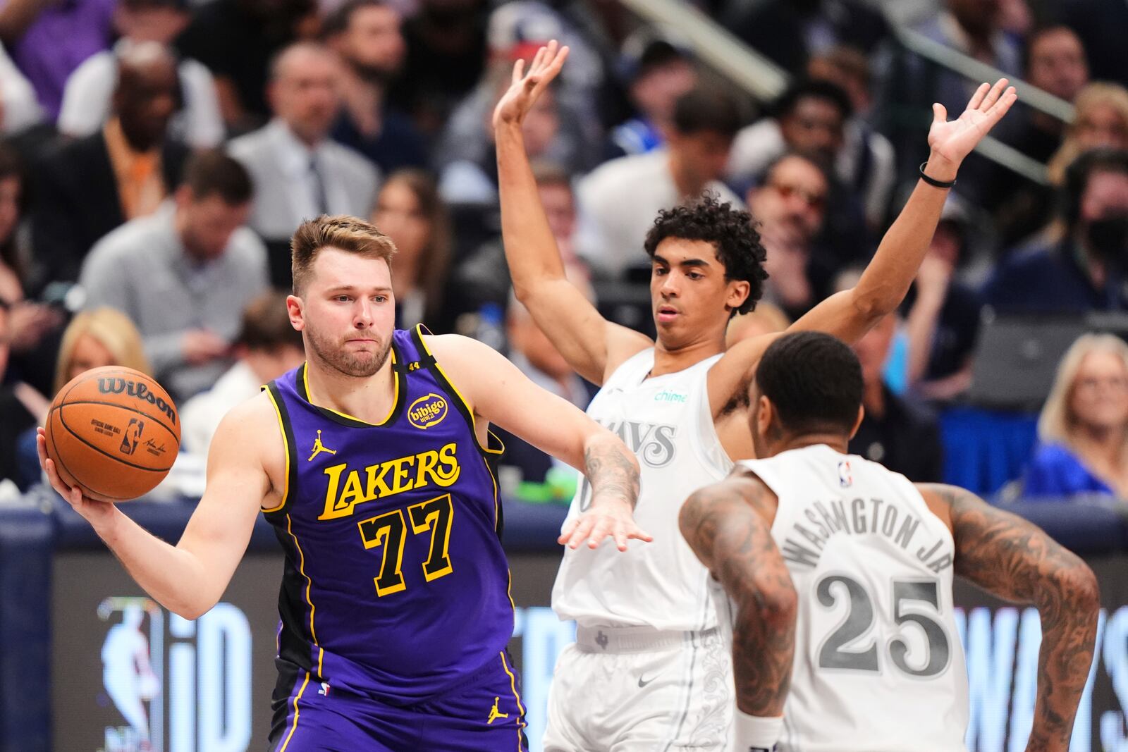 Los Angeles Lakers' Luka Doncic (77) makes a pass as Dallas Mavericks' P.J. Washington (25) and Max Christie, right rear, defend in the second half of an NBA basketball game in Dallas, Wednesday, April 9, 2025. (AP Photo/LM Otero)