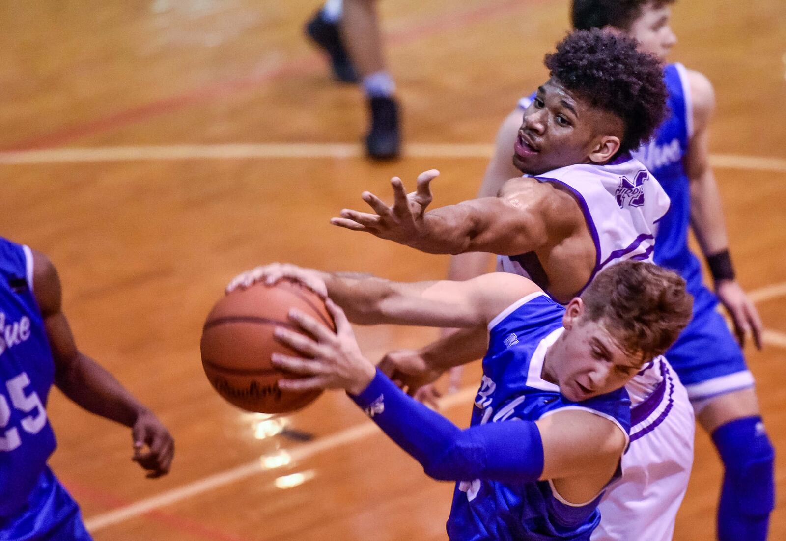 Hamilton’s Payton Pennington grabs the ball in front of Middletown’s Jawunn Bailey on Friday night at Wade E. Miller Gym in Middletotwn. NICK GRAHAM/STAFF