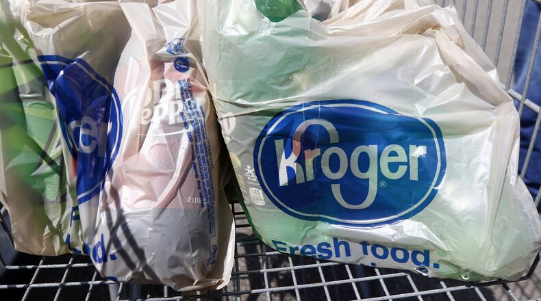 In this June 15, 2017, photo, bagged purchases from the Kroger grocery store in Flowood, Miss., sit inside this shopping cart. Kroger reports financial results on Wednesday, March 7, 2018. (AP Photo/Rogelio V. Solis)