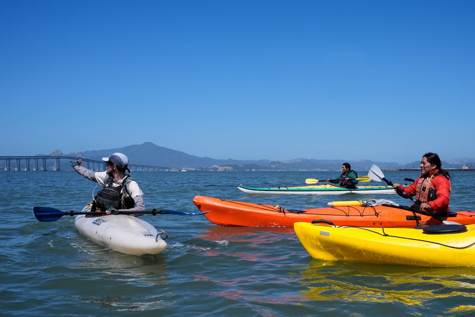 Casey Stewart, left, directs a delegation of Indigenous leaders from Ecuador on a path to kayak and see the Chevron Long Wharf, Thursday, June 19, 2025, in Richmond, Calif. (AP Photo/Godofredo A. Vásquez)