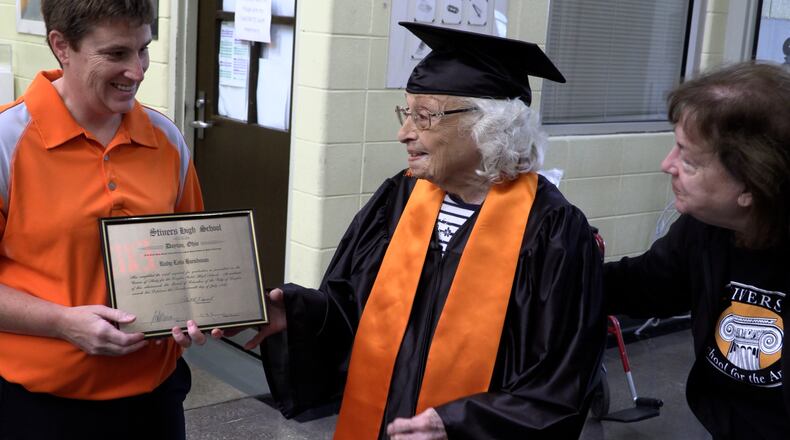 Ruby Lois Hicks, 96, gets her Stivers High School diploma from Liz Whipps, (right) Dean of Arts, and Sarah Bennett, president of the alumnae association. JEFF CROWELL/CONTRIBUTED