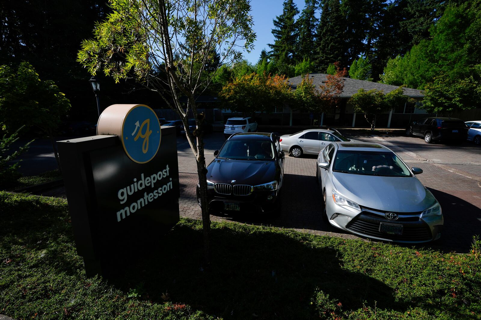 Children are dropped off at the Guidepost Montessori school on Friday, July 18, 2025, in Beaverton, Ore. (AP Photo/Jenny Kane)