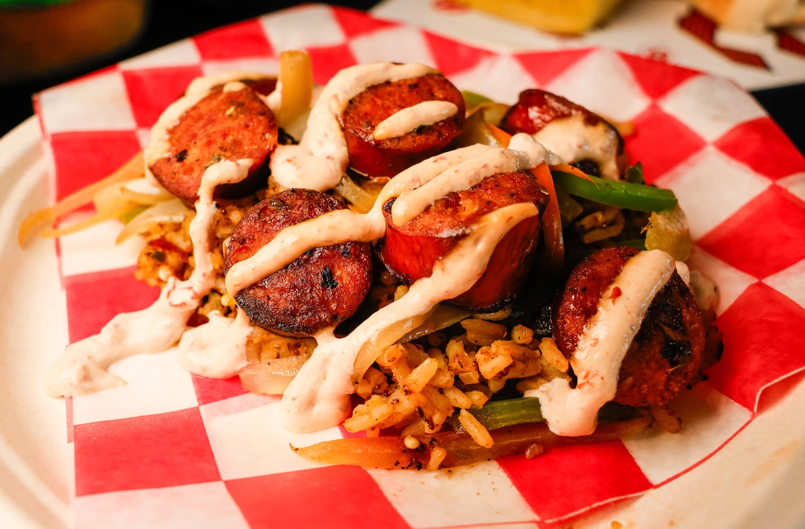 The Cincinnati Reds show off new food options coming to Great American Ballpark this season during a preview event Friday, March 20, 2026 inside The Handlebar at the Riverfront Club. This is the new Hempler's Jalapeno Cheddar Cajun Bowl with Hempler's jalapeno cheddar sausage bites with sauteed peppers and onions on dirty Cajun rice topped with Cajun cream sauce.  NICK GRAHAM/STAFF