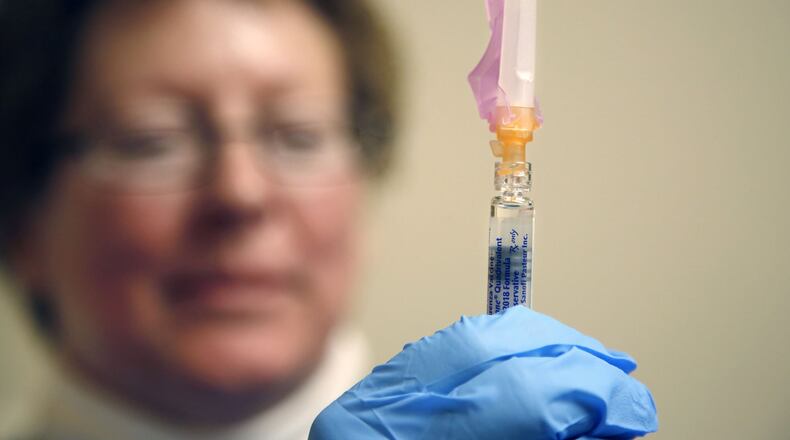 Nurse Debbie Parker prepares flu vaccine for patients at the Montgomery County Public Health Clinic in downtown Dayton. TY GREENLEES / STAFF