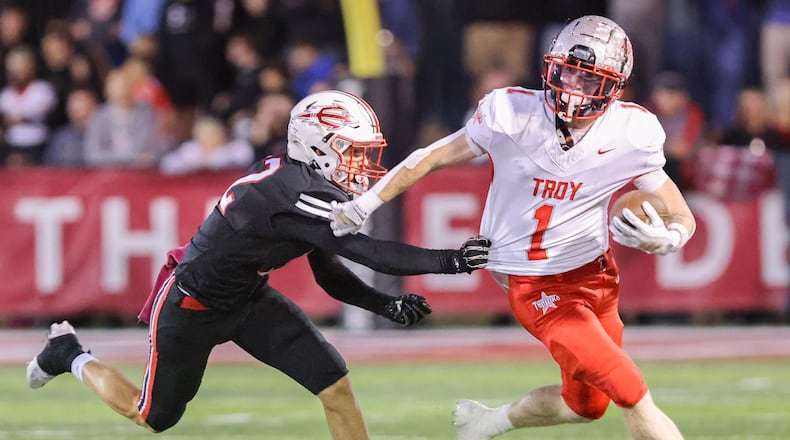 Troy senior halfback  Aidan Gorman tries to fight off Tippecanoe's Max Deckard during the first quarter of a Miami Valley League game on Friday, Oct. 17 at Tipp City Park. Tippecanoe won 21-0 to hand Troy its first shutout loss since Week 3 of 2022. BRYANT BILLING / STAFF