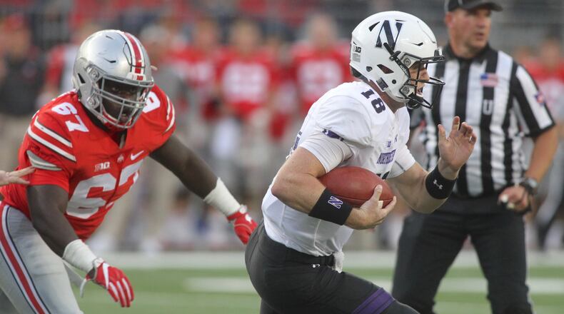 Ohio State’s Robert Landers chases Northwestern’s Clayton Thorson on Saturday, Oct. 29, 2016, at Ohio Stadium in Columbus. David Jablonski/Staff