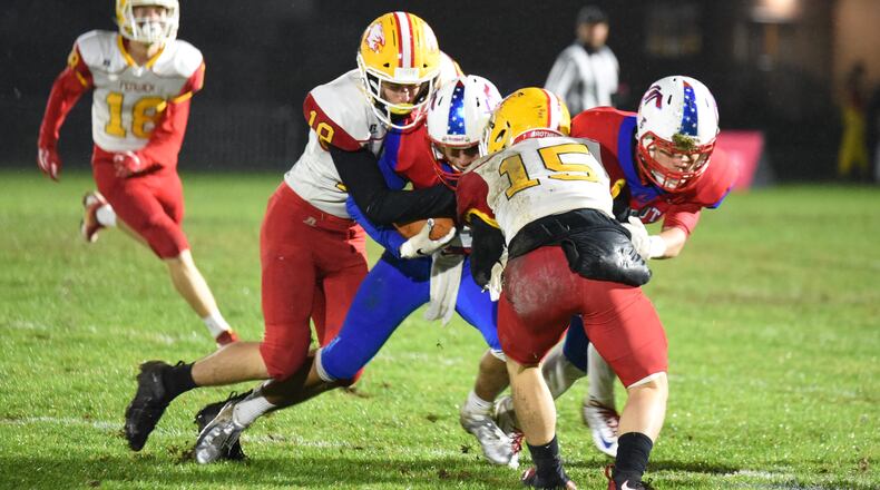 Fenwick’s Tyler Houck (19) and Henry Nenni (15) tackle Carroll’s Johnathan Beiring (11) on Friday night in Riverside. The visiting Falcons emerged with a 42-41 victory. CONTRIBUTED PHOTO BY ANGIE MOHRHAUS