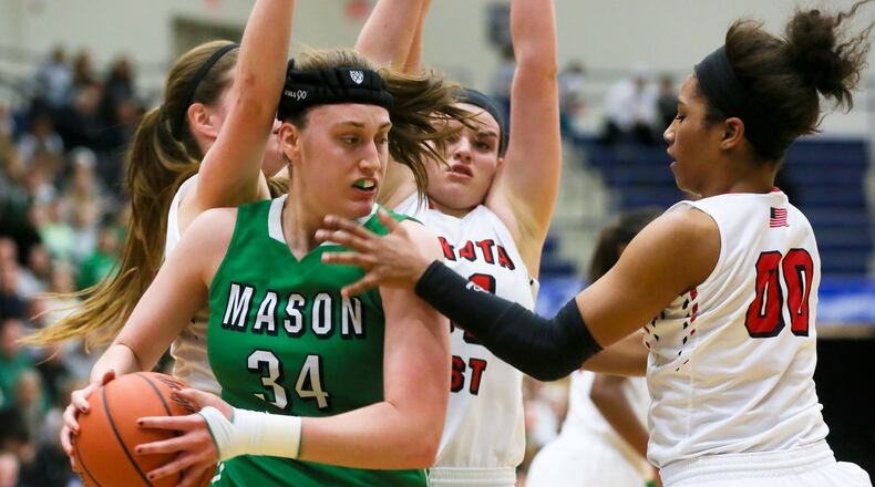 Mason forward Lauren Van Kleunen (34) is surrounded by Lakota West defenders, including Lexi Wasan (middle) and Danielle Wells (00), during their Division I regional final at Fairmont’s Trent Arena on March 5, 2016. Mason won 49-30. GREG LYNCH/STAFF