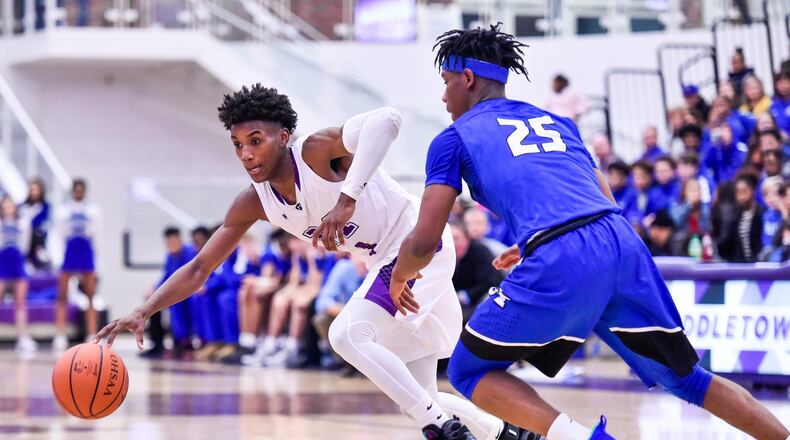 Middletown’s Aaron Jones dribbles the ball while being defended by Hamilton’s D’Marco Howard during Friday night’s game at Wade E. Miller Arena in Middletown. NICK GRAHAM/STAFF