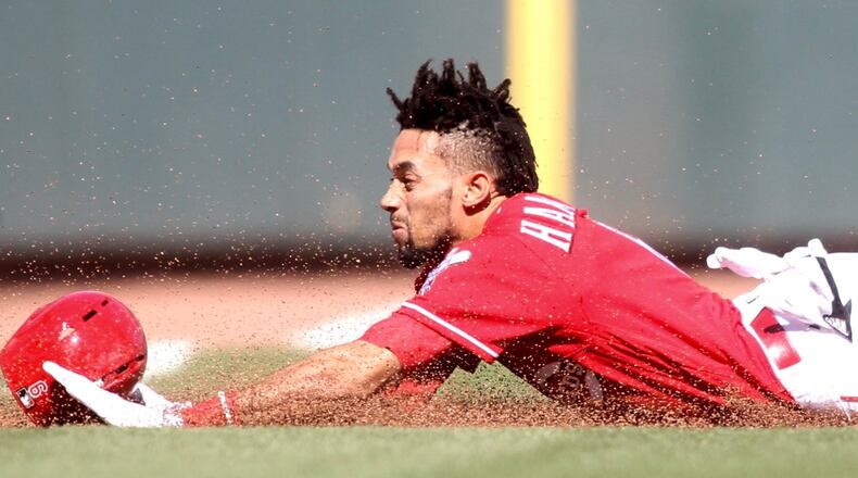 Billy Hamilton slides into third with a triple against the Giants on Sunday, May 7, 2017, at Great American Ball Park in Cincinnati. David Jablonski/Staff
