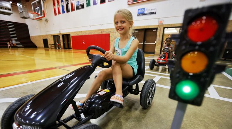 Kiya Laudick, 5, drives a pedal car during Lakota Safety Village.  Lakota schools, West Chester Police Department, Butler County Sheriff's Office and other have partnered for Lakota Safety Village to teach young children going into kindergarten school etiquette, bus and car safety, fire safety and more at Lakota Freshman School in West Chester Township. NICK GRAHAM/STAFF
