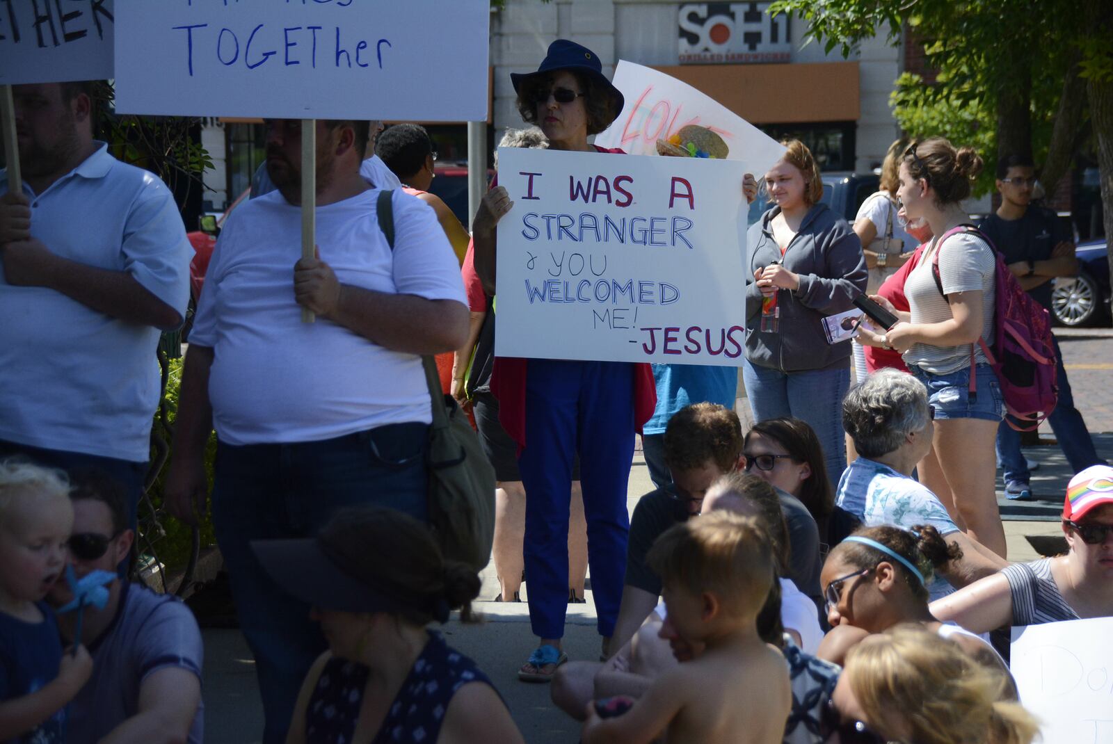 Protesters hold up signs on Saturday, June 30, 2018, at Memorial Park in Uptown Oxford during a rally protesting President Donald Trump’s immigration policy where migrant children were separated from their families as they crossed the U.S.-Mexico border over the past several weeks. Trump has since signed an order directing that families not be separated, though thousands are still separated, according to national media reports. MICHAEL D. PITMAN/STAFF