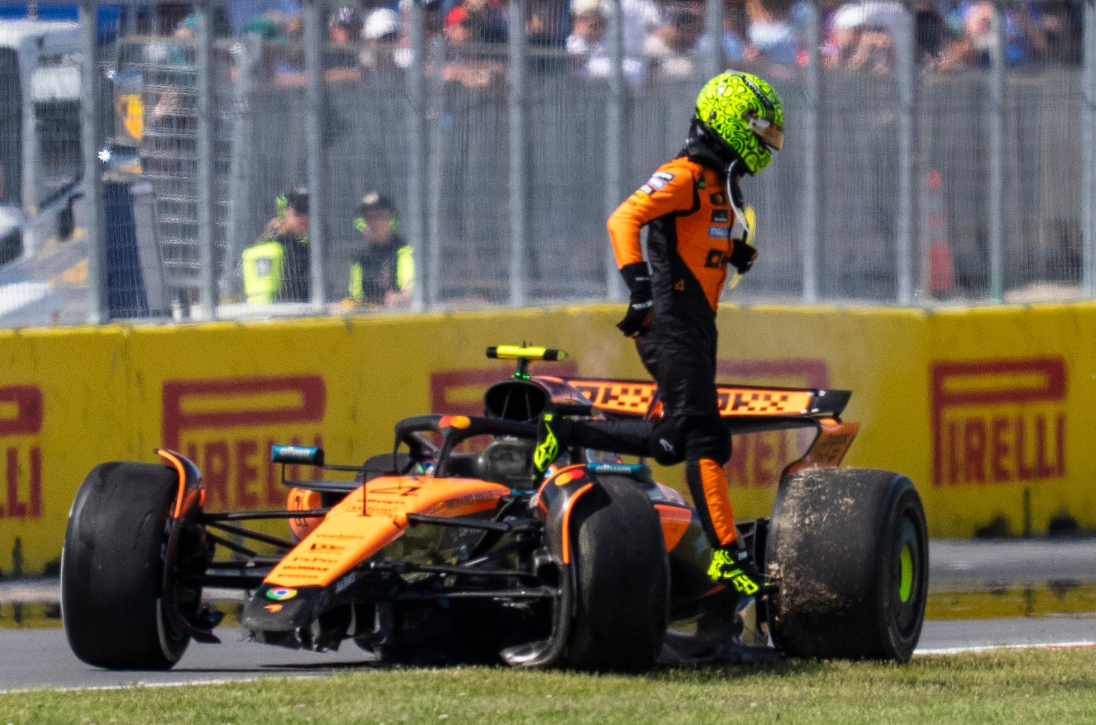 McLaren driver Lando Norris, of the United Kingdom, walks away from his car following a collision during the F1 Canadian Grand Prix auto race in Montreal, Sunday, June 15, 2025. (Christopher Katsarov/The Canadian Press via AP)
