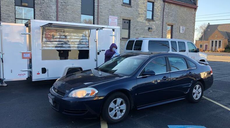 SHALOM volunteers serve homeless people breakfast three days a week from a food trailer at First United Methodist Church. Volunteer coordinator Bill Fugate said SHALOM has seen an increased need for the free meals. FILE PHOTO