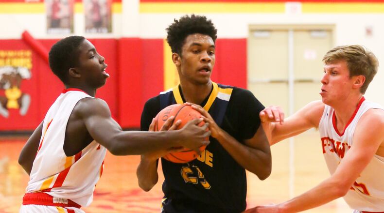 Monroe forward Tristan Backas (23) drives between two Fenwick defenders during a game in Middletown on Jan. 17, 2017. GREG LYNCH/STAFF