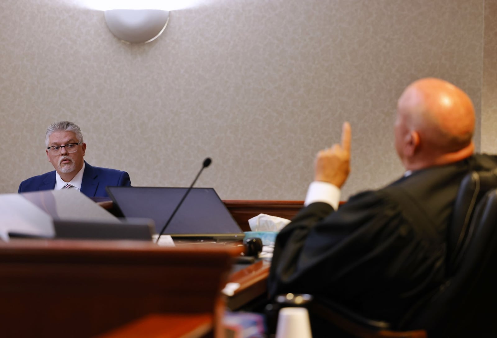 Butler County assistant prosecutor Lance Salyers, left and Judge Keith Spaeth discuss a bond issue during an arraignment of Justin Dennis on 8 counts of sexual battery involving a student while he was a teacher at Lakota East High School. NICK GRAHAM/STAFF