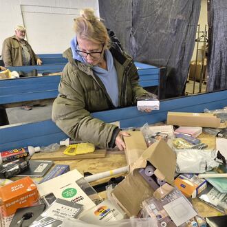 Nicole Bock, of Enon, hunts through a bin of goods at Nifty Thrifties Bargain Bins, 6845 Dayton Springfield Road, in search of bargains. MICHAEL KURTZ / STAFF