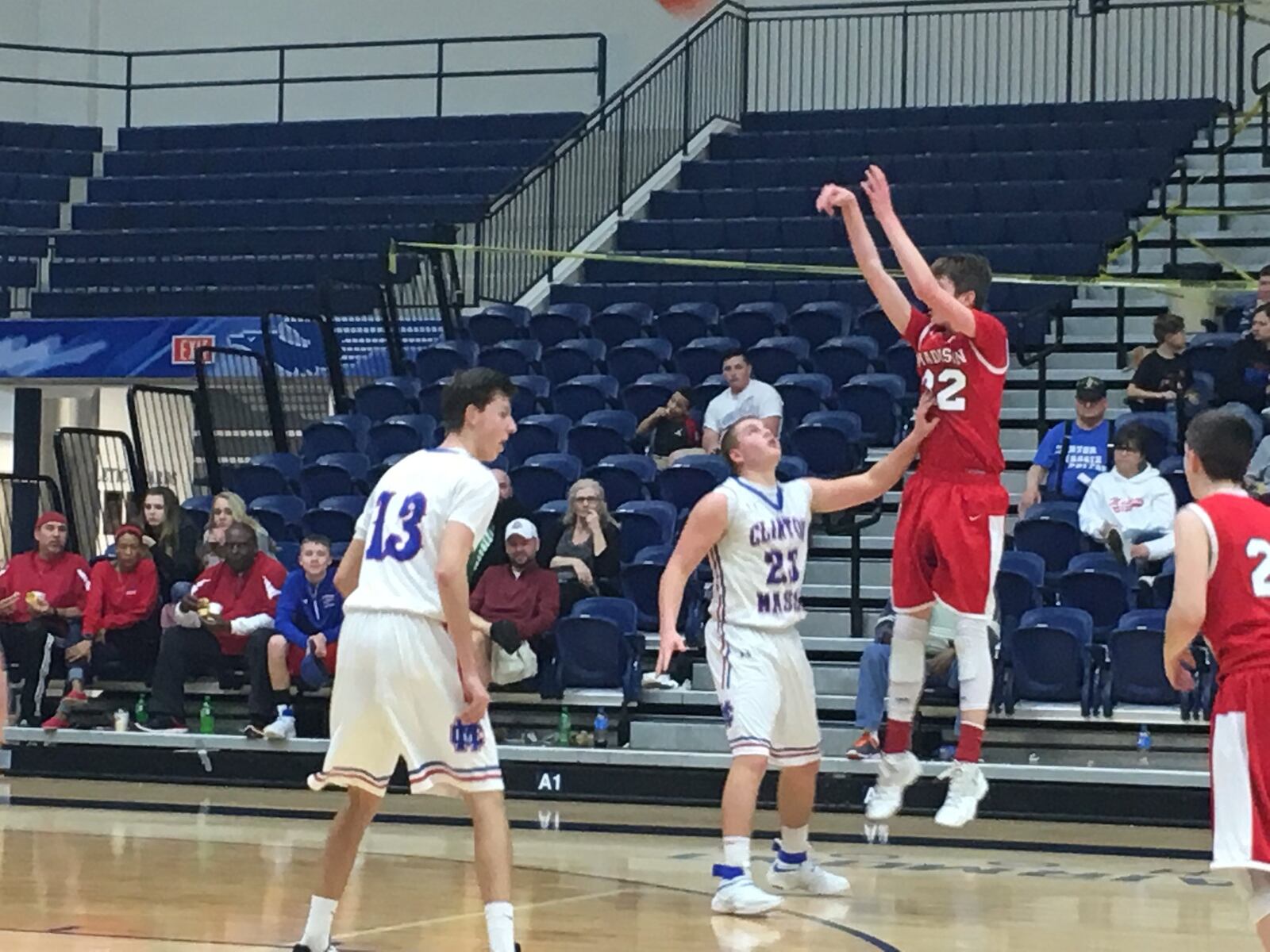Madison’s Grant Whisman follows through on a shot over Clinton-Massie’s Trey Uetrecht (35) on Friday night during Division II sectional play at Fairmont’s Trent Arena. RICK CASSANO/STAFF