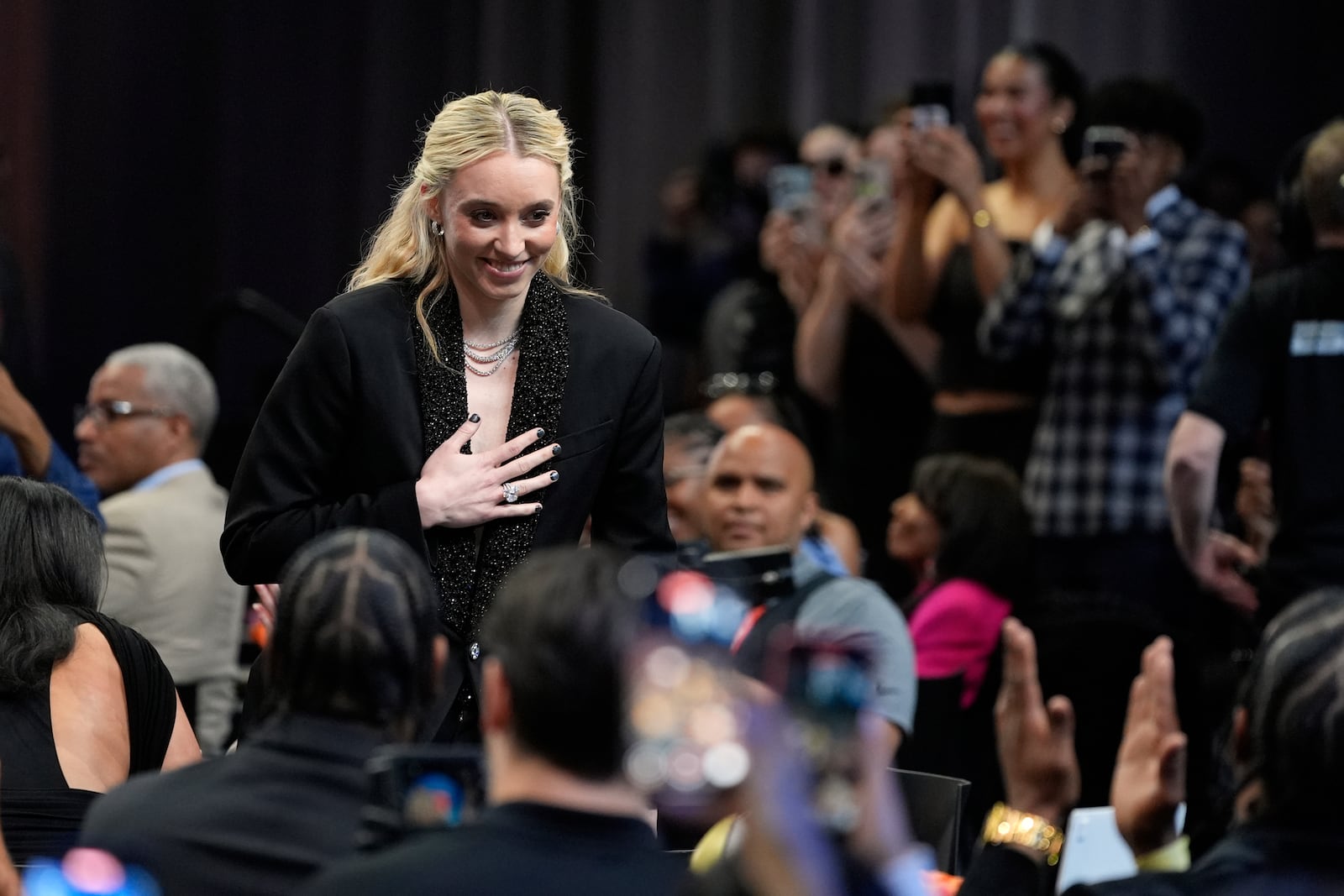 UConn's Paige Bueckers reacts after being selected first overall by the Dallas Wings during the first round of the WNBA basketball draft, Monday, April 14, 2025, in New York. (AP Photo/Pamela Smith)