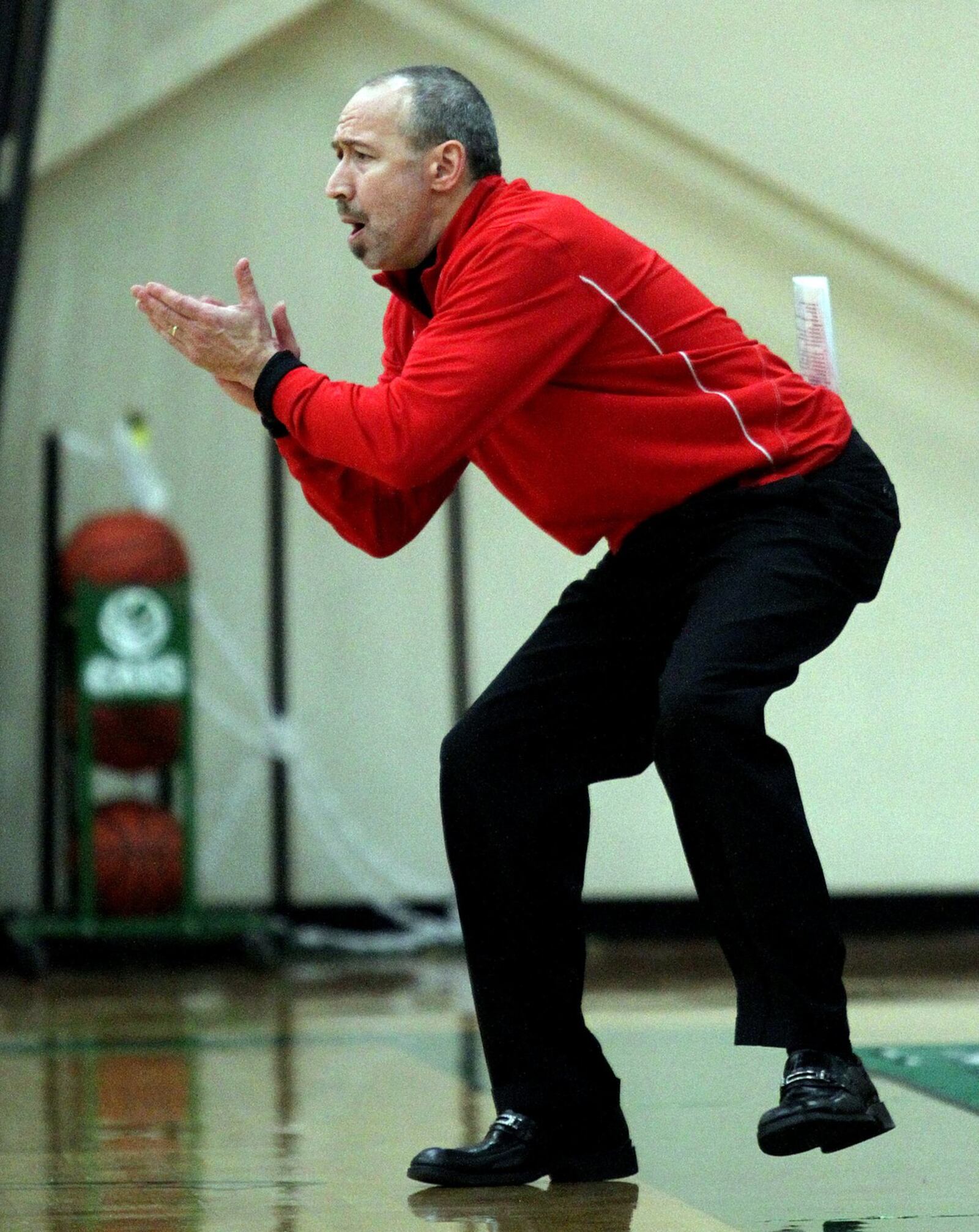 Lakota West coach Andy Fishman applauds a play against St. Ursula during a Division I sectional game at Harrison on Feb. 19, 2013. CONTRIBUTED PHOTO BY E.L. HUBBARD