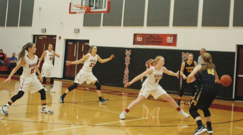 Madison’s Ally King (11) leads the defensive effort against Monroe’s Sam Schwab (22), who’s passing the ball to teammate Sophie Sloneker (14), during a Nov. 29 at Madison. Also near the play for the host Mohawks are Grace Baker (15), Tara Price (22) and Carley McMonigle (32). Monroe won 50-39. RICK CASSANO/STAFF