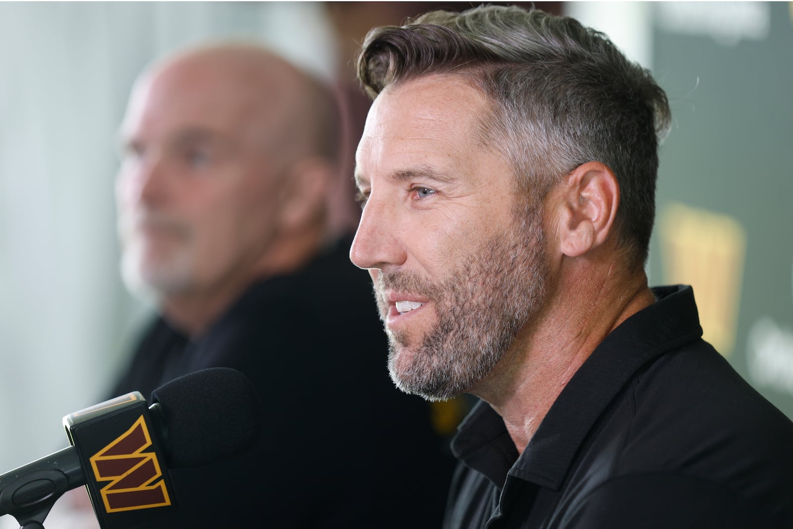 Washington Commanders general manager Adam Peters, right, speaks as head coach Dan Quinn, left, looks on during a news conference at the NFL football team's training camp in Ashburn, Va., Tuesday, July 22, 2025. (AP Photo/Luis M. Alvarez)