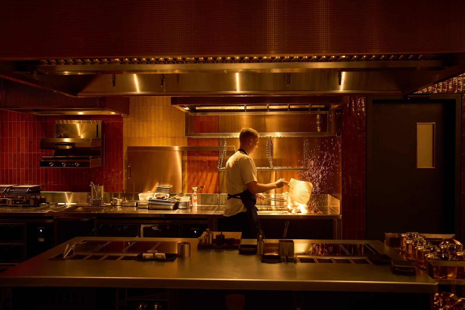 A chef lights charcoal at FZN Restaurant on Palm Jumeirah in Dubai, United Arab Emirates, Friday, June 13, 2025. (AP Photo/ Fatima Shbair)