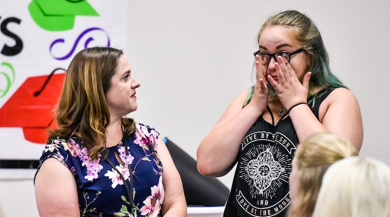 Case worker Amanda Hinkle congratulates Corina Jean on her graduation during the Butler County Children Services graduation ceremony for kids involved in the foster care program Thursday, June 21 in Hamilton. Corina graduated from Belmont High School and plans to attend Sinclair Community College to be a pharmacy tech. NICK GRAHAM/STAFF