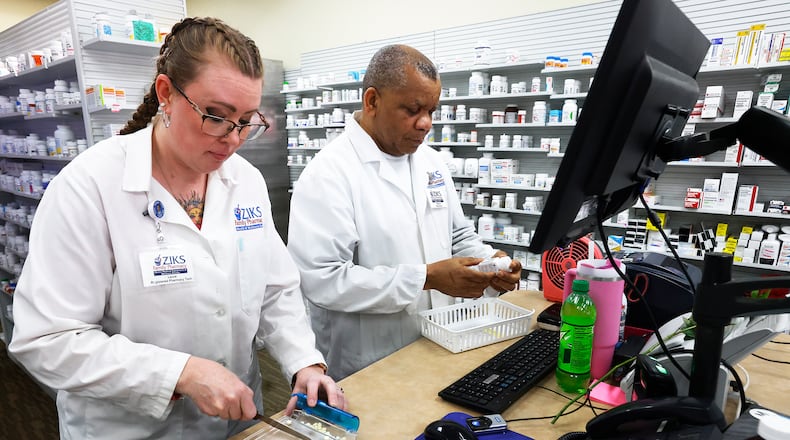 Laura Duffin, Pharmacy tech, left, and Nnodum Iheme Pharmacist, prepare prescriptions Friday, Feb. 14, 2025 at Ziks Family Pharmacy located at 1130 W Third St, Dayton. MARSHALL GORBY\STAFF