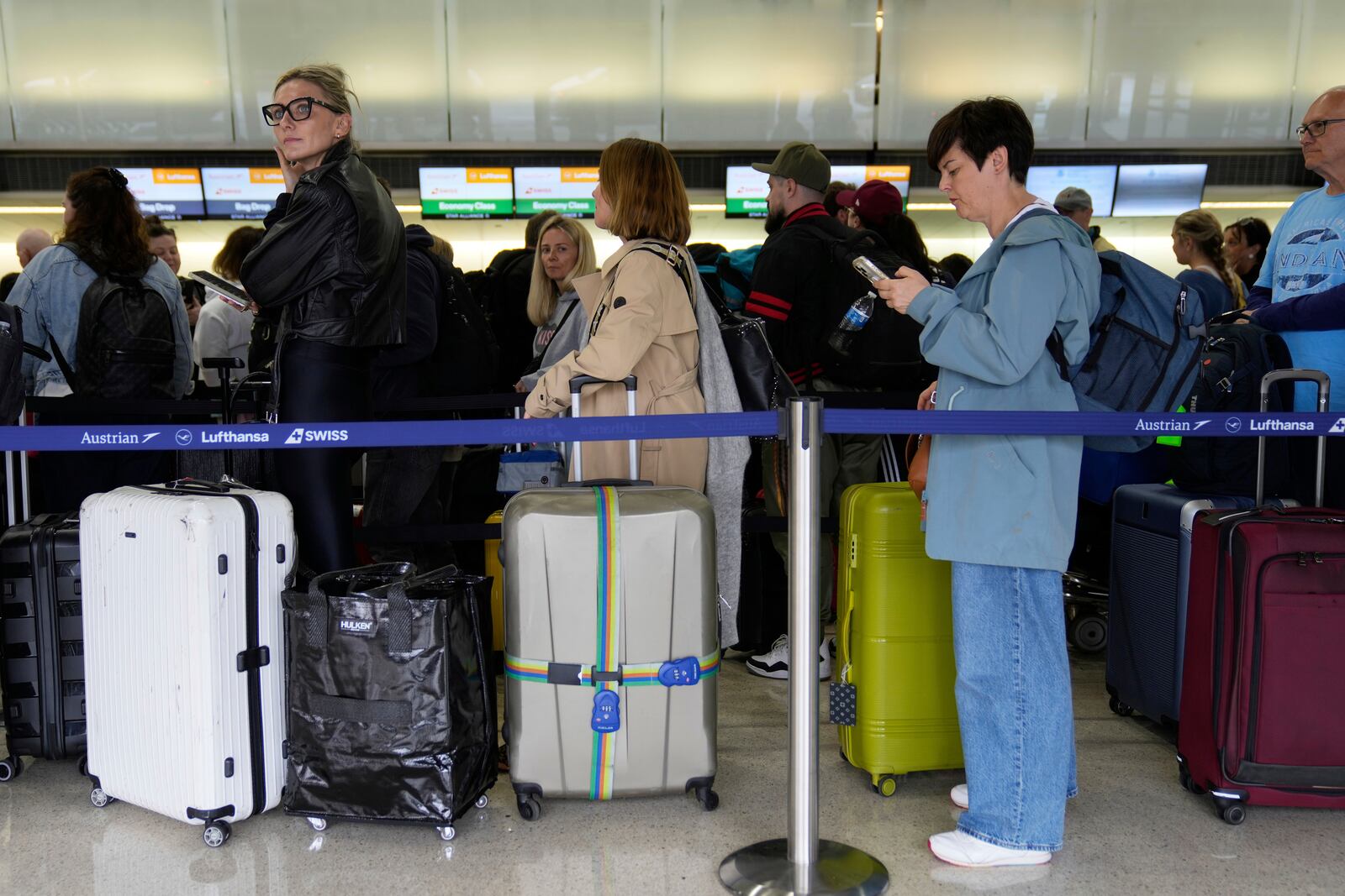 Travelers wait to check into their flights at Newark Liberty International Airport in Newark, N.J., Monday, May 5, 2025. (AP Photo/Seth Wenig)