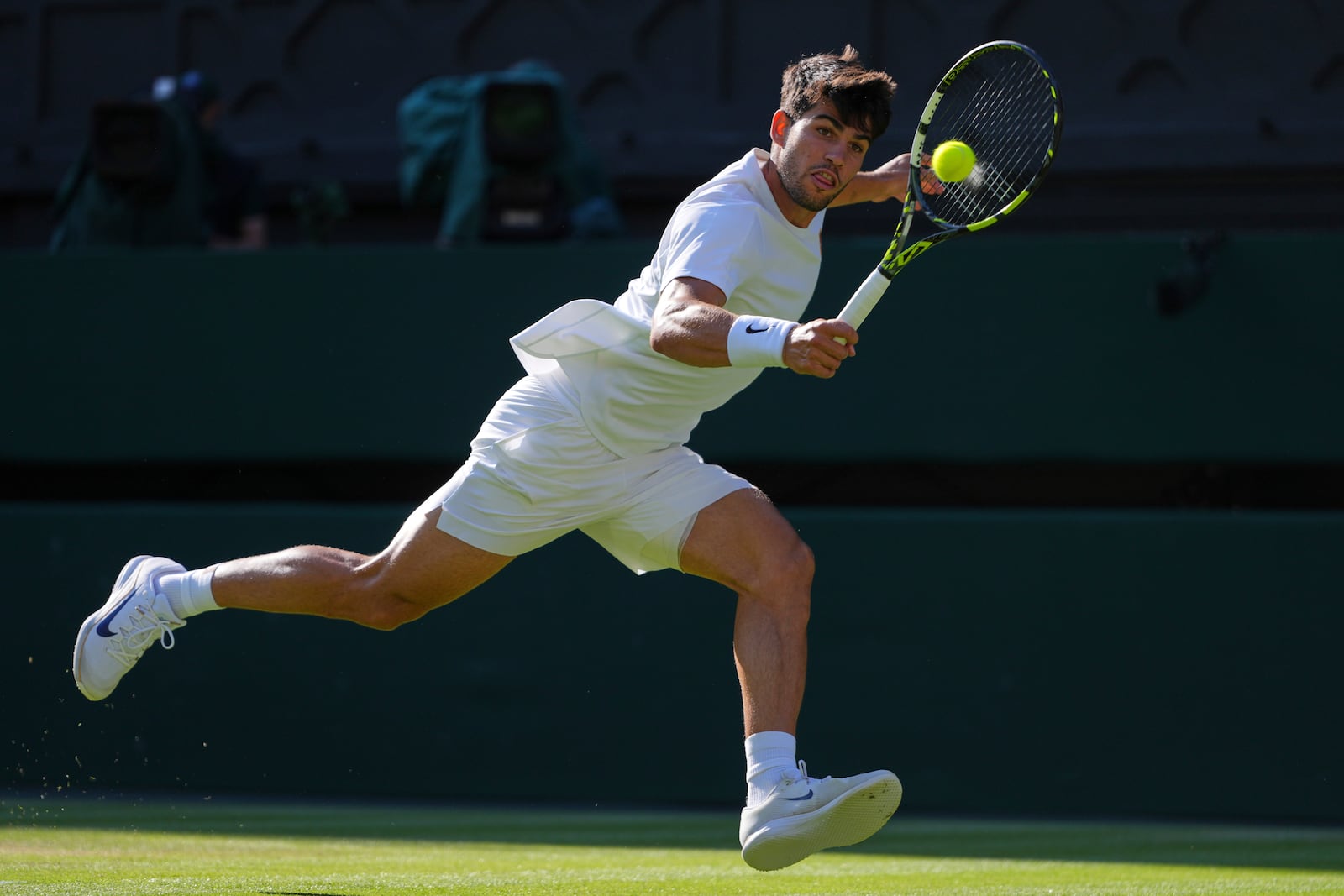Spain's Carlos Alcaraz returns to Britain's Cameron Norrie during a quarterfinal men's singles match at the Wimbledon Tennis Championships in London, Tuesday, July 8, 2025. (AP Photo/Kirsty Wigglesworth)