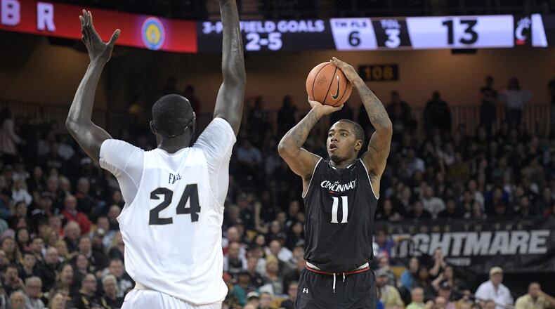 Cincinnati forward Gary Clark (11) goes up for a shot in front of Central Florida center Tacko Fall (24) during the first half of an NCAA college basketball game Tuesday, Jan. 16, 2018, in Orlando, Fla. (AP Photo/Phelan M. Ebenhack)